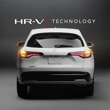 2027 Honda HR-V EX-L in Platinum White Pearl rear view in a studio with HR-V Technology text (Subcompact Crossover SUV).