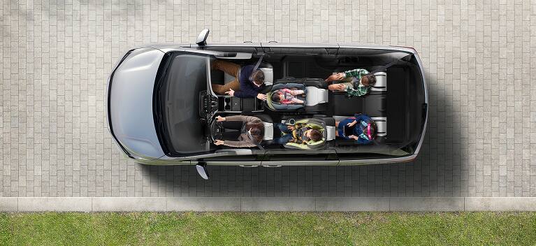 2027 Honda Odyssey Elite in color top on a paved driveway showing the interior seating layout (Minivan).