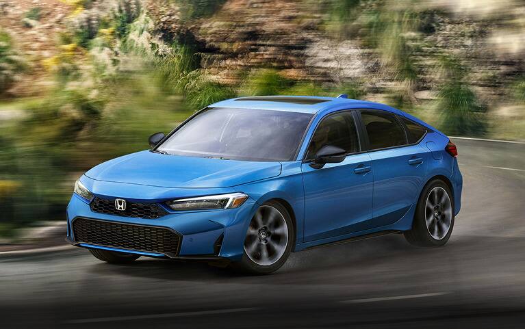 2027 Honda Civic Hatchback Sport Touring Hybrid in Boost Blue Pearl front driving on a winding road (Compact Hatchback).