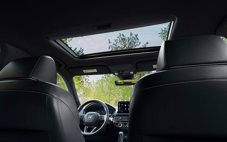 2027 Honda Civic Hatchback Sport Touring Hybrid interior detail of the power moonroof and overhead console (Compact Hatchback).