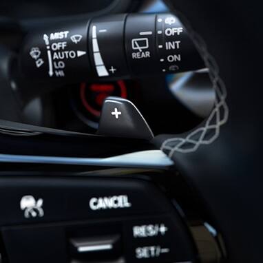 2027 Honda Civic Hatchback Sport Touring Hybrid close up of the steering wheel paddle shifters (Compact Hatchback).